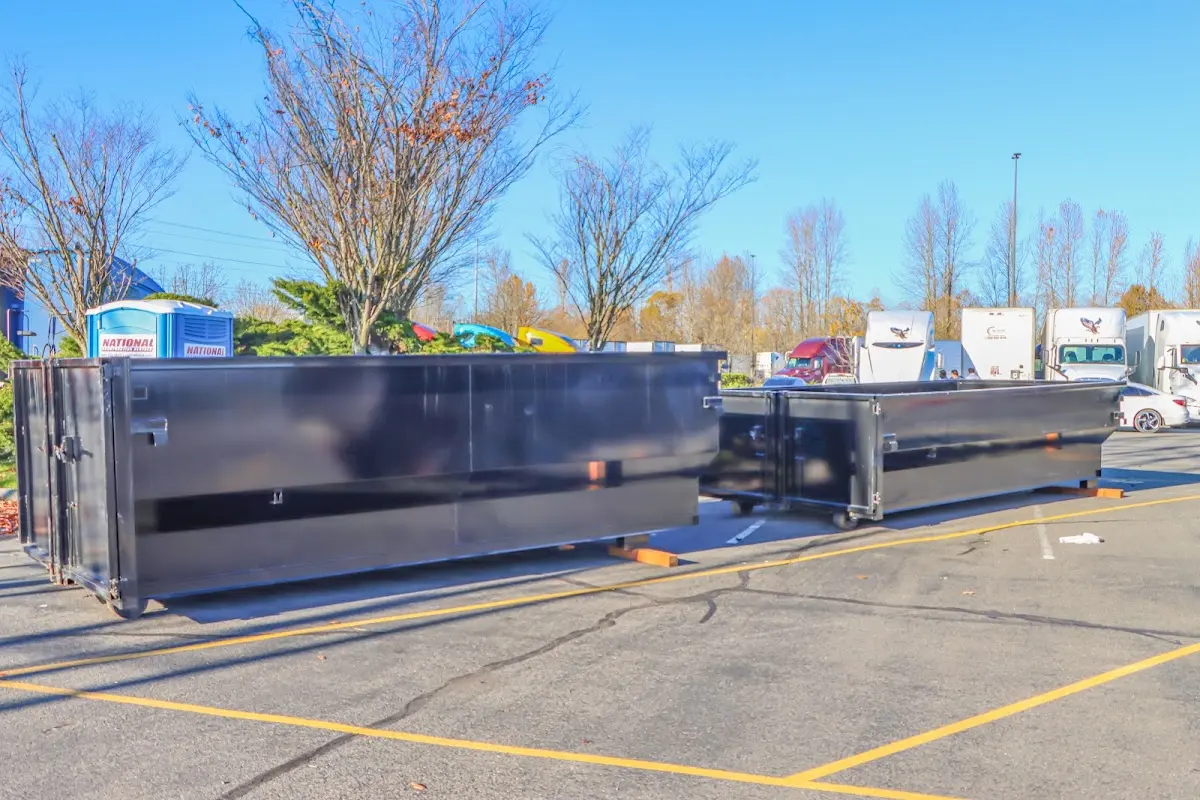 Professional dumpster rental service with roll-off container on residential driveway in Colorado Springs